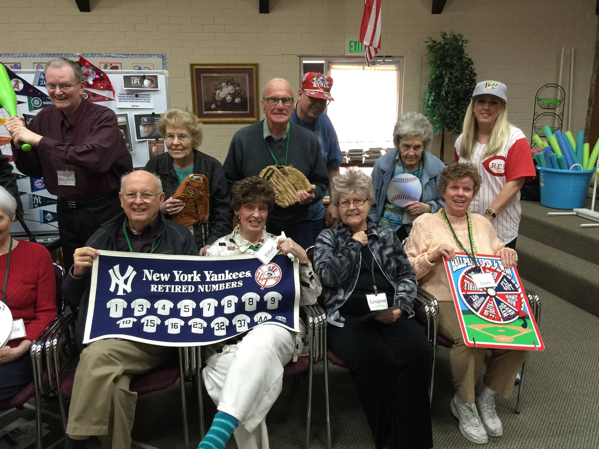 Aspen Senior Center participants holding a baseball chart and memorabilia